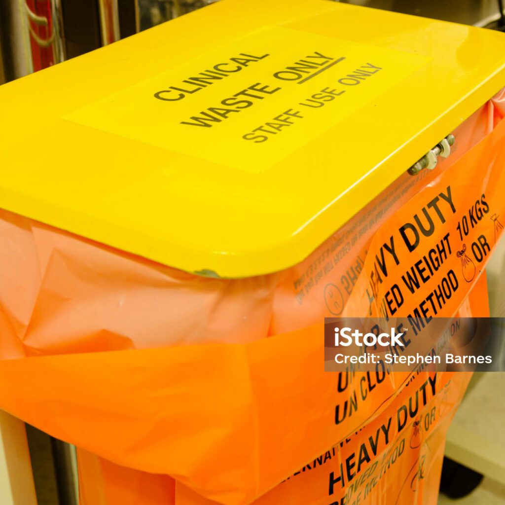 Clinical waste bin in a hospital clinical room.